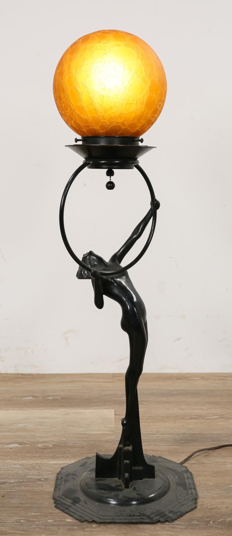 Frankart Figural Lamp with Amber Glass Shade: Frankart painted metal figural lamp with amber glass shade. Female nude holding a hoop upon a skyscraper base. Circa 1930. 10 1/2" L x 10 1/2" W x 33"H. Figure mounted on a new base. Paint restoration