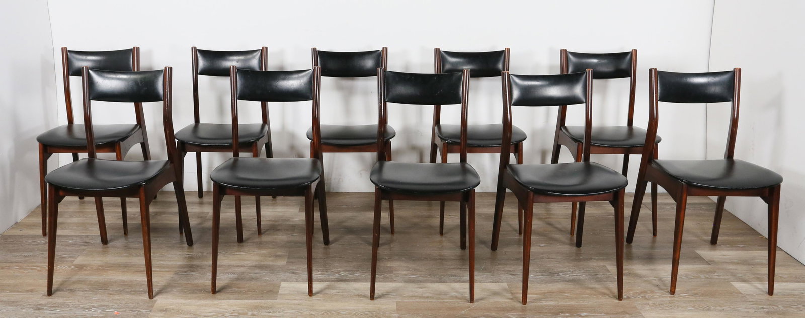 Set of 10 Danish Modern Dining Chairs: Set of 10 Danish modern dining chairs. Mid 20th century. Rosewood, black leather seat and back splat, tapered dowel legs. Back splat to one chair repaired, remnants of glue on back of one chair. Some 