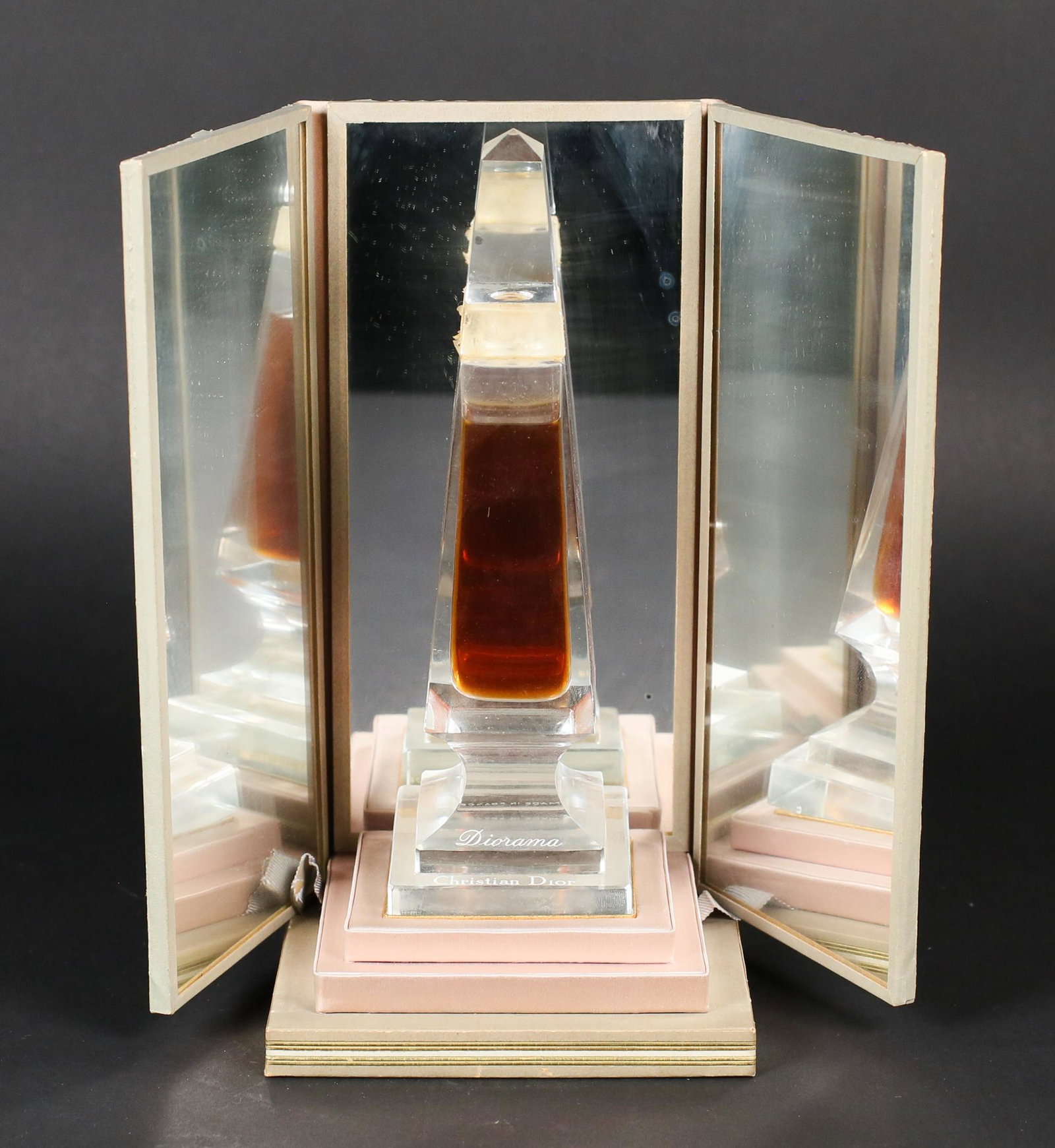 Baccarat Dior Diorama Perfume Bottle: Baccarat design for Christian Dior Diorama clear crystal perfume bottle, stopper and mirrored dresser box. Loss to the frost collar. Left side mirror is loose from box. Chip to base, front. Wear to th