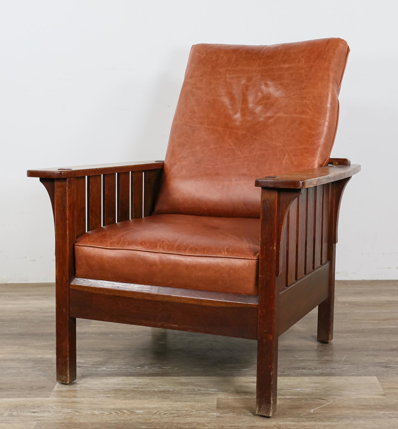 Stickley Associated Cabinet Makers Morris Chair: Stickley Associated Cabinet Makers (New York, 1916-1919). Closed arm quarter sawn oak Morris chair. Round sticker label. "Stickley Syracuse & Fayetteville N.Y." Replaced seat and back cushions. Wear t