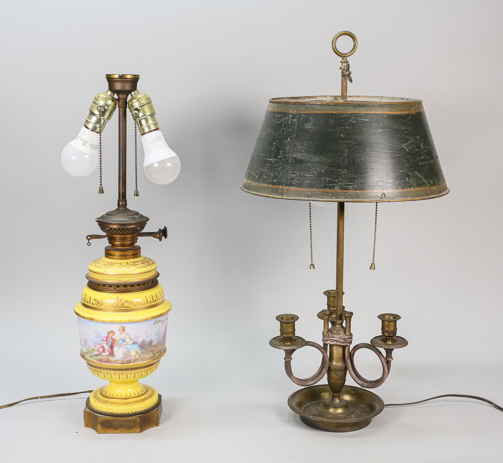 Sevres Style Porcelain Lamp and Bouillotte Lamp: Two lamps, an Edward Miller and Co. porcelain lamp with painted Rococo pastoral scene, and a brass bouillotte lamp with green and black painted tole shade. American and French, Early 20th Century. Bot