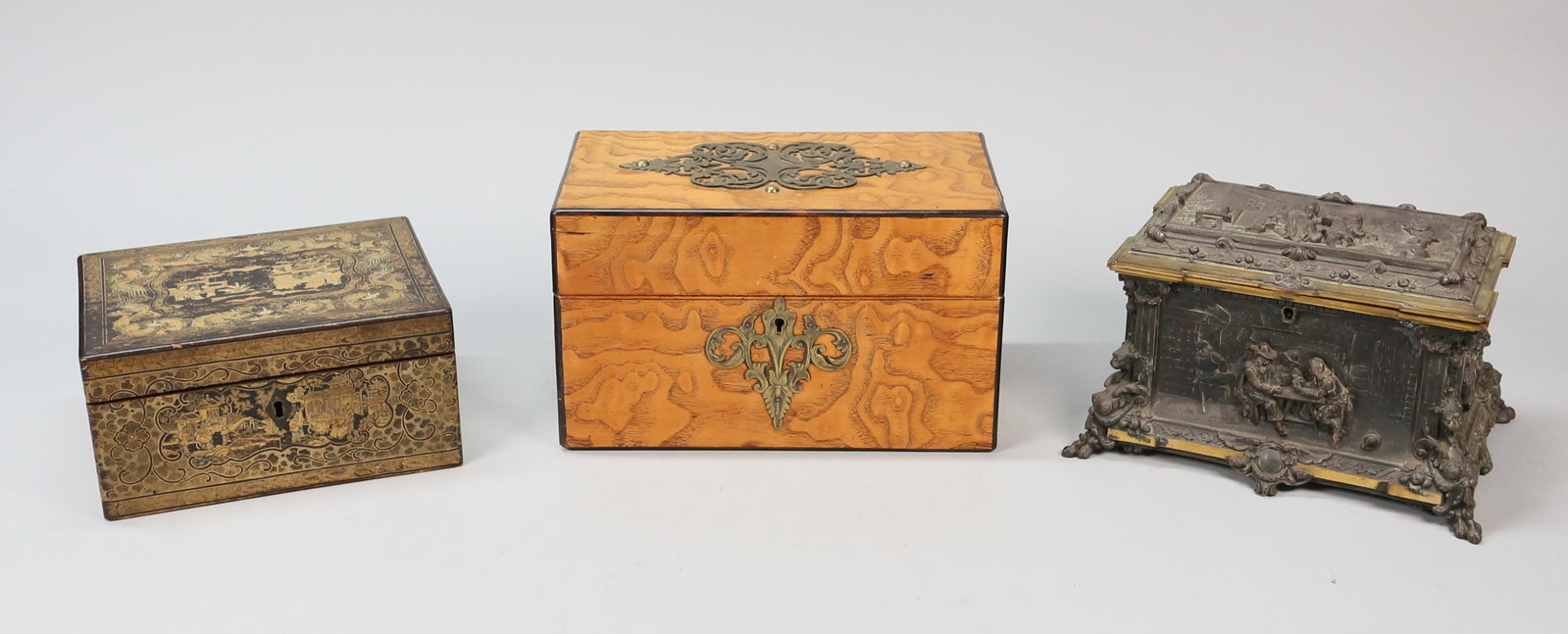 Grouping of Tea Caddies & Dresser Box: Lot of 3 boxes. Wood tea caddy with brass scroll decoration, 10"L x 6"D x 6"H; Chinese lacquer tea caddy with gilt dragons and village scene and chased metal interior lids, 8"L x 6 1/4"D x 4"H; patina