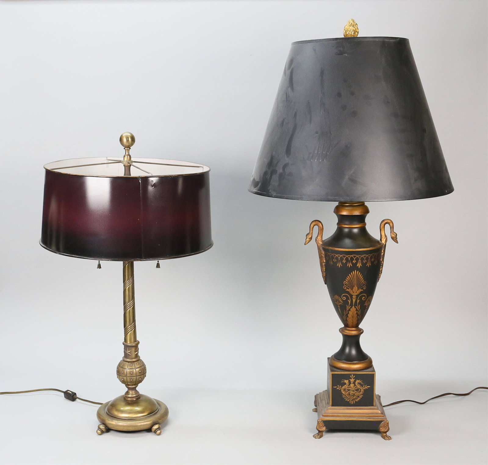 2 Lamps: 2 table lamps. Hand painted tole urn lamp, with swan form handles, 32"H including finial; brass lamp with star motif base and tole shade, 24"H including finial.