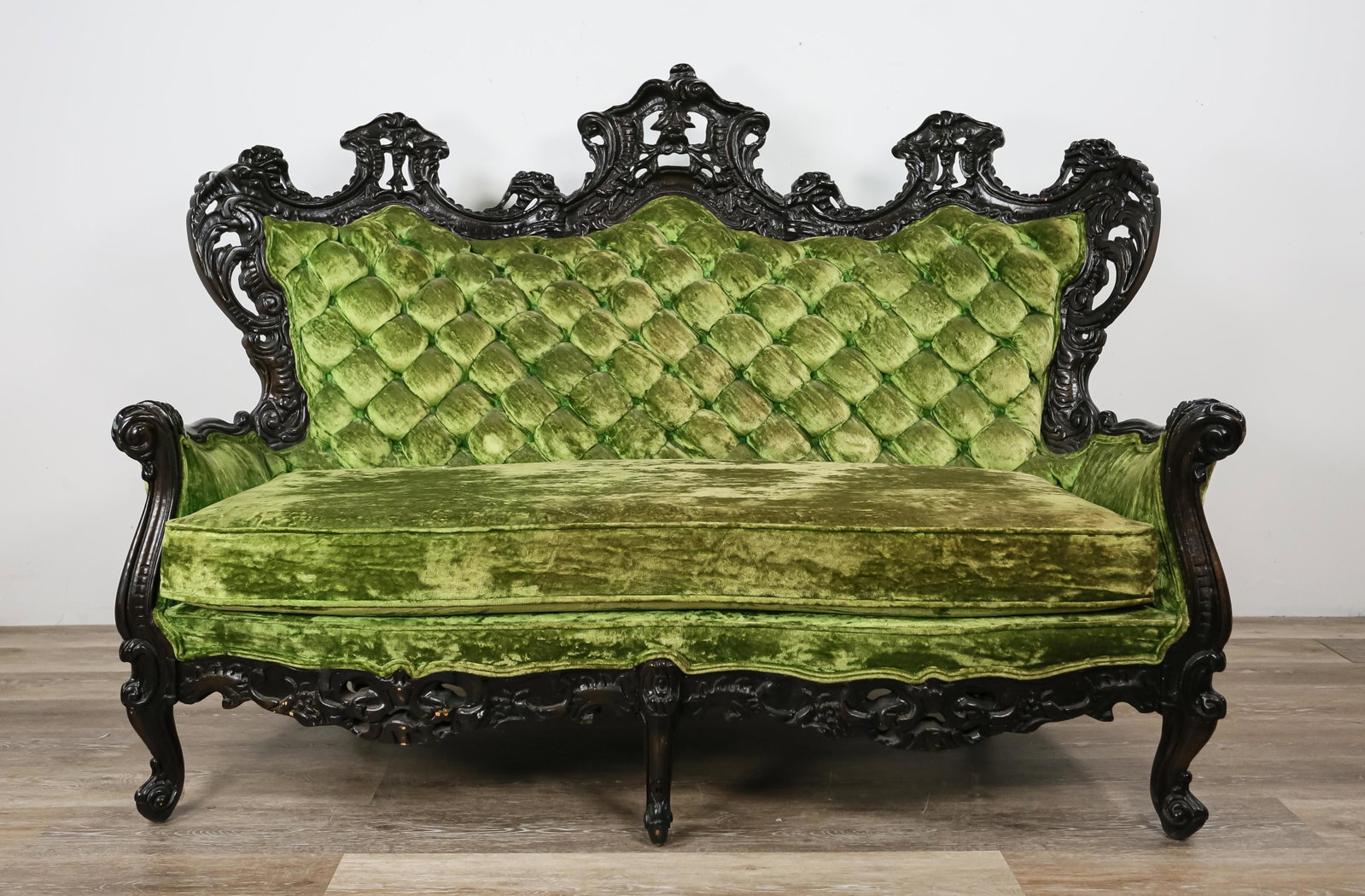 American Rococo Revival Style Settee: American Rococo Revival style settee. Later 20th Century. Green crushed velvet and carved ebonized wood. S. Miller tag underside cushion. Some fading to velvet, losses to wood on left side of carved s