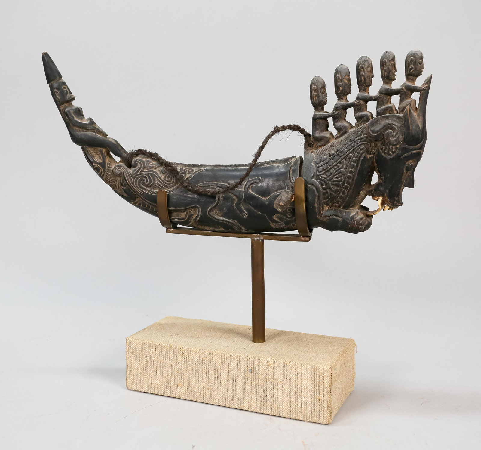 Ritual Specialist's Medicine Horn Batak: Ritual specialist medicine horn or Naga Morsarang of the Batak people from Sumatra, Indonesia. Incised hollow horn with figural carvings. The front of the horn representing a deity with bone teeth. On