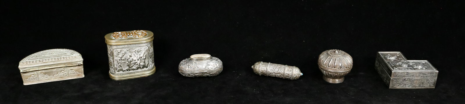 Grouping of Asian Metal Objects: 3 Chinese metal boxes with auspicious decorations, genre scenes. Burmese metal lime box and nut box. Southeast Asian scroll holder. Chinese box with genre scene: 2 3/4" H.