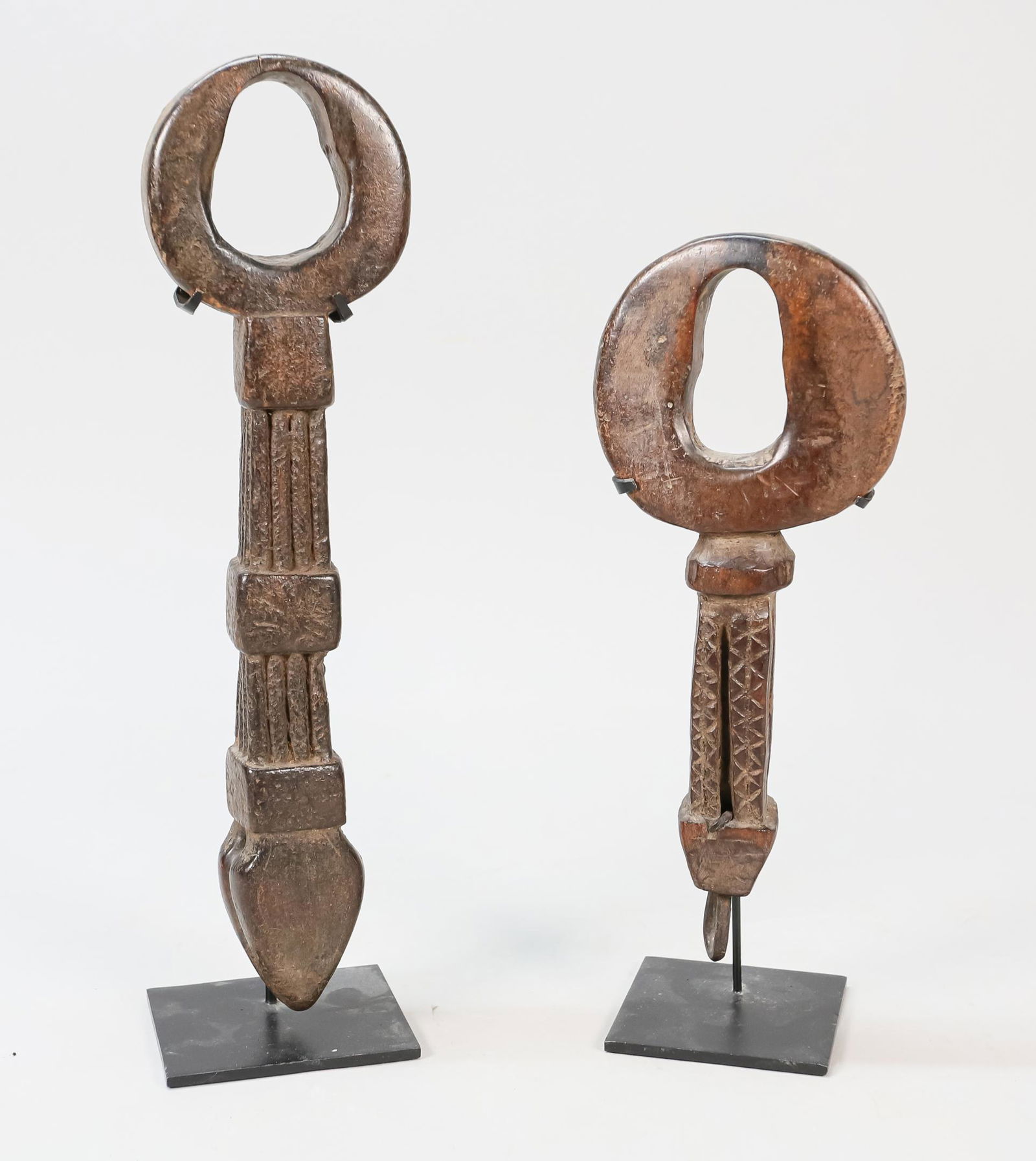 2 Tibetan Butter Churns: 2 Tibetan yak butter churns. Carved wood. Largest: 13" L. Scratches. Line to 1 churn scoop. Wear throughout both.