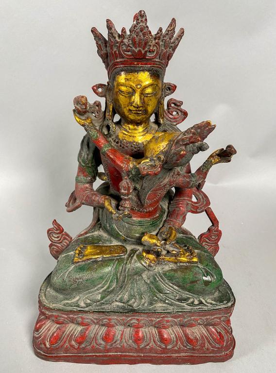 Tibetan Yab Yum Polychrome Bronze Deity: Circa 17th to 18th Century Tibetan bronze statue with two deities together in an interpretation of wisdom and compassion. Bronze gilt with polychrome paint. They hold a bell and vajra in their hands d