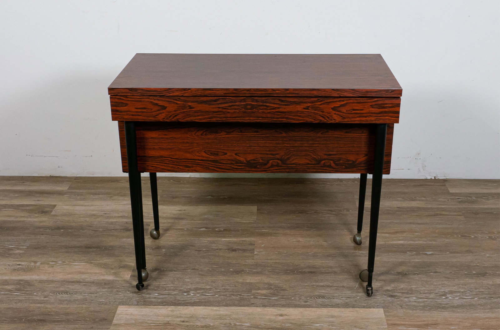 Mid Century Modern Tambour Dining Table and Server: Mid Century Modern tambour dining table and server. Mid 20th Century. Laminate wood paneling, metal legs on casters. Server converts into a long dining table from a pullout mechanism. Minimal scuffing