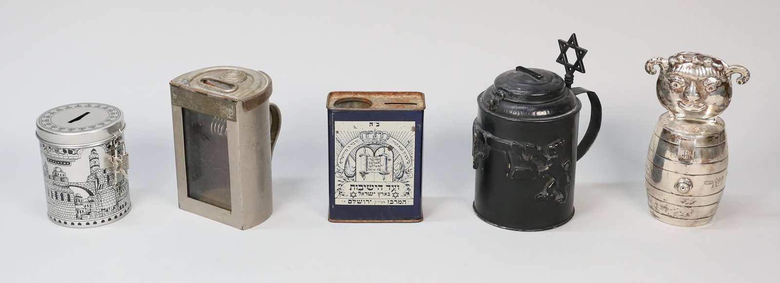 Grouping of 5 Tzedakah Boxes: 5 tzedakah boxes. Vintage tin box, Hungarian box "for poor brides", lion box, contemporary tin box, figural silver box with barrel. Silver box unmarked, acid tested as silver. Hungarian box 5 3/4"H, s