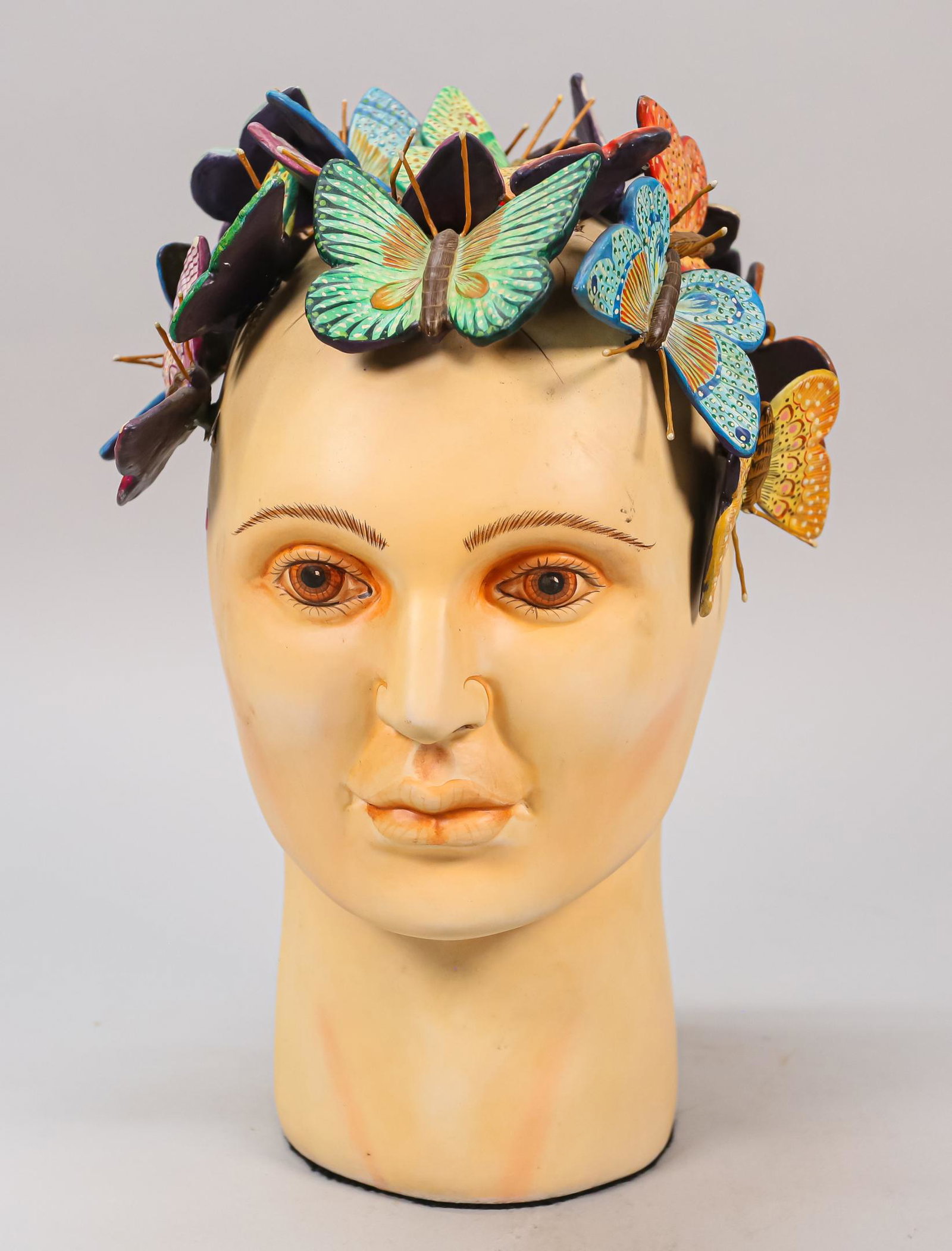 Sergio Bustamante Resin Sculpture: Sergio Bustamante (Mexican, b. 1949) resin sculpture, human head with butterflies. Signed. 12 3/8" H. Slight discoloration around the eyes and eyebrows.