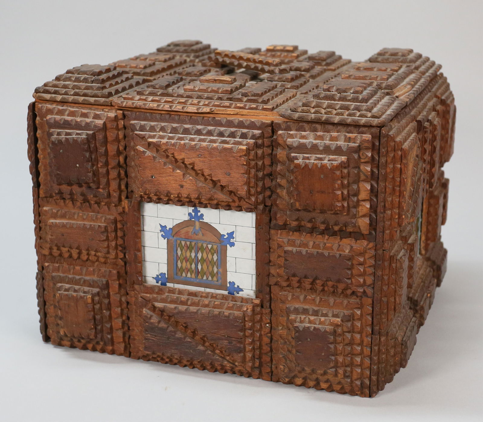 Tramp Art Lidded Box: Lidded tramp art box with 4 hand painted glass panels. 11 3/4"W x 11"D x 9"H including lid. Paint loss to glass panels, minor chips throughout, chips on lid, pieces missing from two corners, piece mis