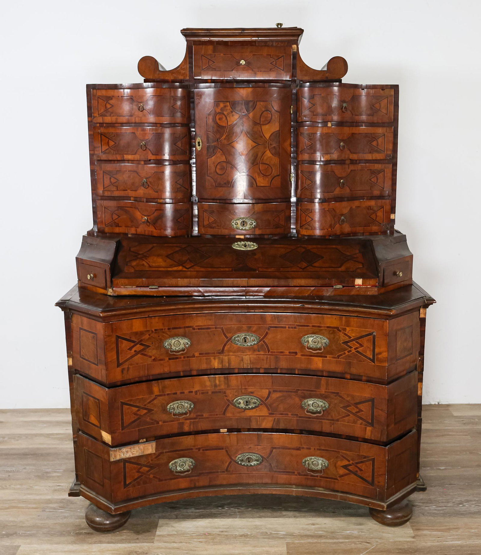 18th Century German Secretary Desk: 18th century German secretary desk. Burled wood, inlaid linear motifs, serpentine form drawers. Heavy losses of veneer throughout. Some drawers are difficult to remove. Lowest drawer is warped and doe