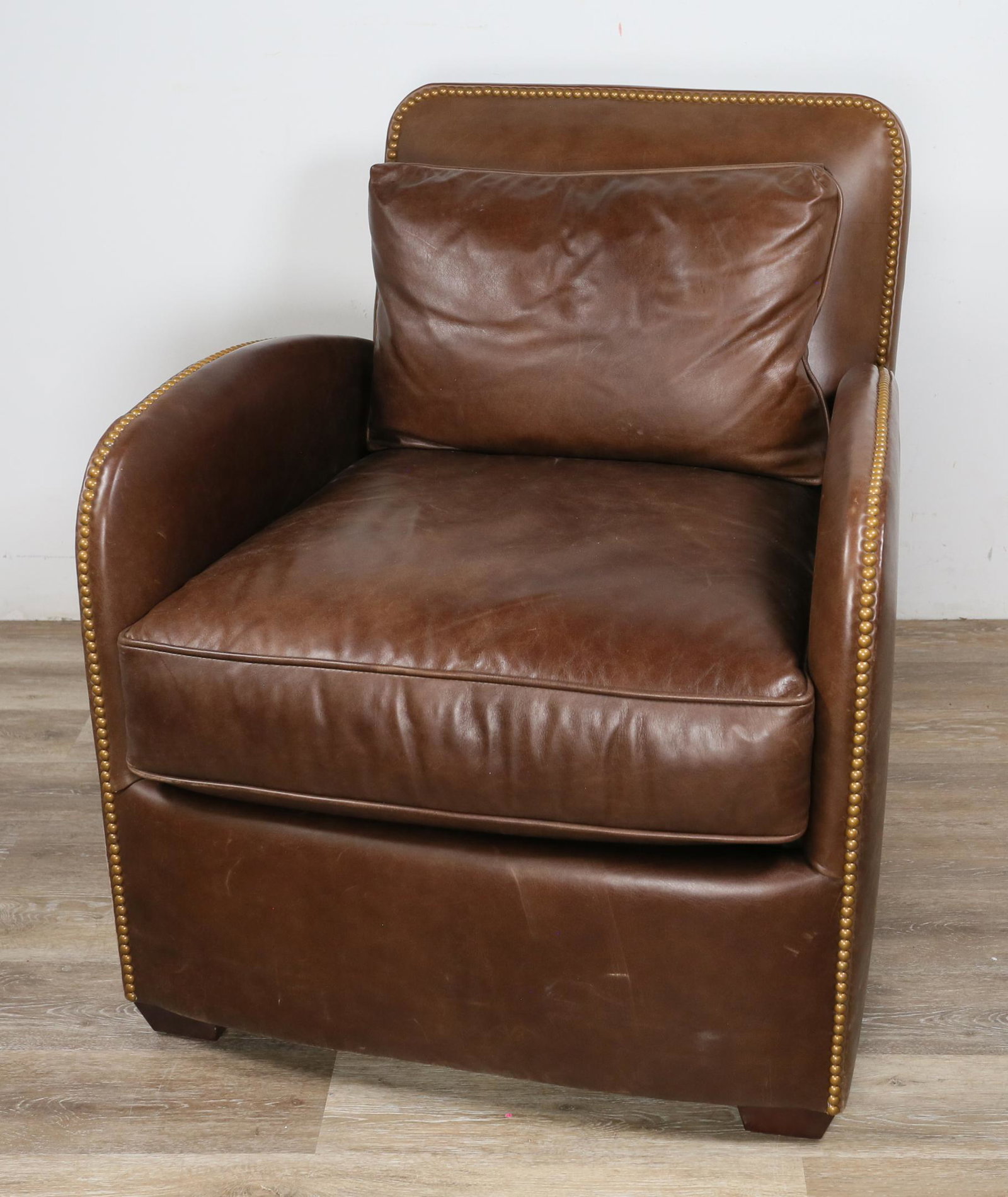 Century Furniture Leather Library Style Armchair: Century Furniture leather library style armchair. Hickory, North Carolina, 20th Century. Brown leather, cushion and pillow, nailhead trim. Century Furniture label on seat underneath cushion. Scratches