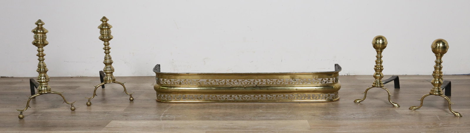 French Brass Andirons and Fire Fender: 2 pairs French brass andirons and fire fender. Small dents and marks throughout guard, crack on one corner, scratches to brass on both pairs of andirons, 1 andiron split at back. Back ball finial miss