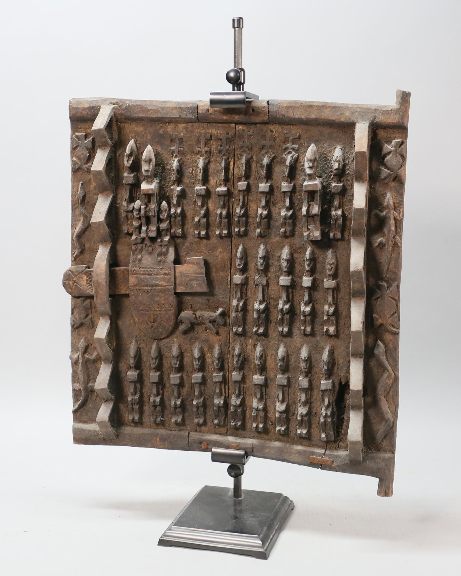 African Mali Dogon Granary Door: African Dogon People (Mali, West Africa) wood granary door. Two panels with repeating figural, animal and geometric motifs. With figural wooden lock. Patina to wood. 18" H x 16 3/4" W