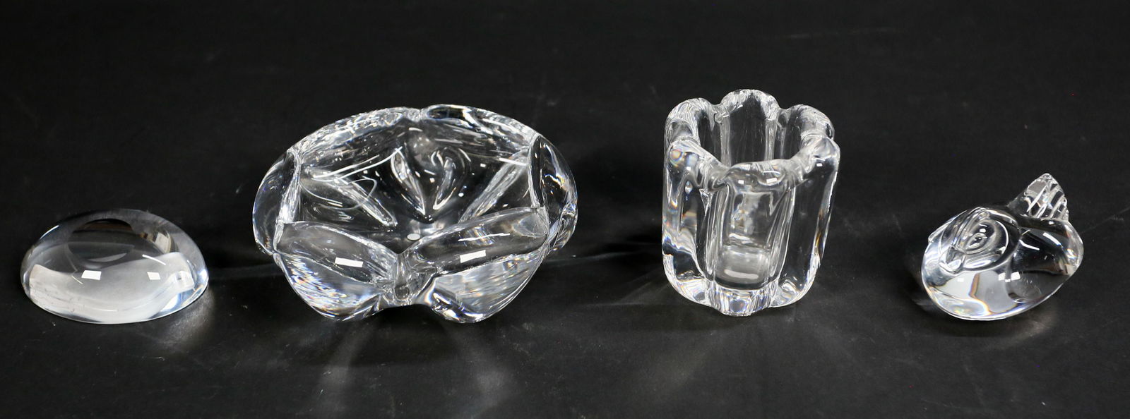 4 Piece Art Glass Lot: 4 piece art glass lot. Signed Orrefors bowl, 2"H x 4 3/4"-diameter; signed Orrefors candle holder, 2 3/4"H; signed Steuben hen hand cooler, 2 1/2"L; bird paperweight, signed illegibly, 3"L.