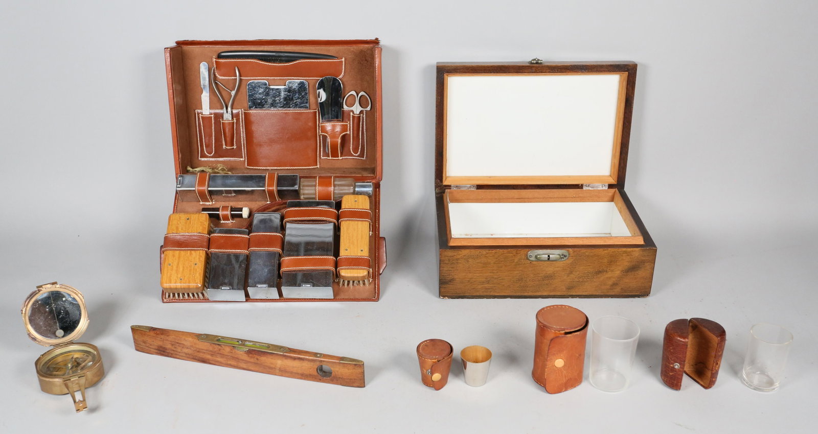Lot of Men's Accessories: Boyle leather 14 piece travel grooming kit, wooden level, Stanley London Natural Sine brass compass, 3 travel cups in leather cases -- 2 glasses and one metal shot glass, wooden humidor box. Humidor 1