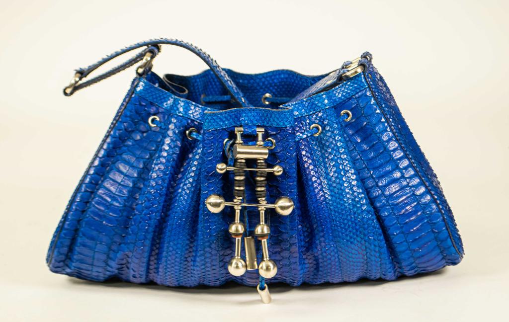 Donna Karan Cobalt Blue Python Leather Hobo Bag: Donna Karan cobalt blue python bag with metal accents, single shoulder strap, blue sued lining with one interior slip pocket and one zippered pocket; good condition with light to no wear, 9"H, 15 1/2"