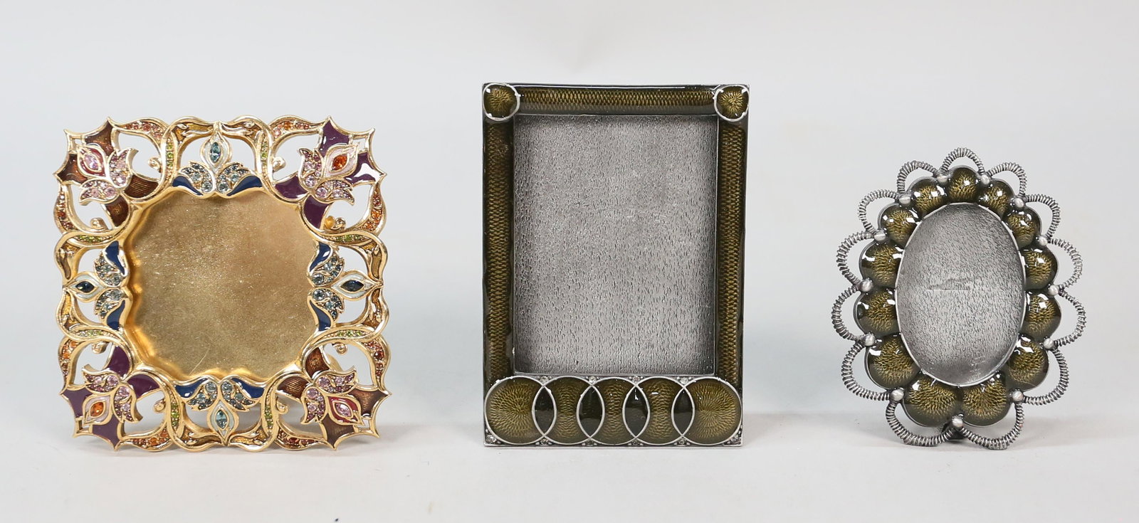3 Jay Strongwater Frames: Jay Strongwater (American, 1960-). 3 enamel frames. Oval frame 3 1/2"H (opening approximately 2"H); rectangular frame 4 1/4"H (opening 3"H); enamel and jeweled square frame, 4"H (opening 2"H). All mar