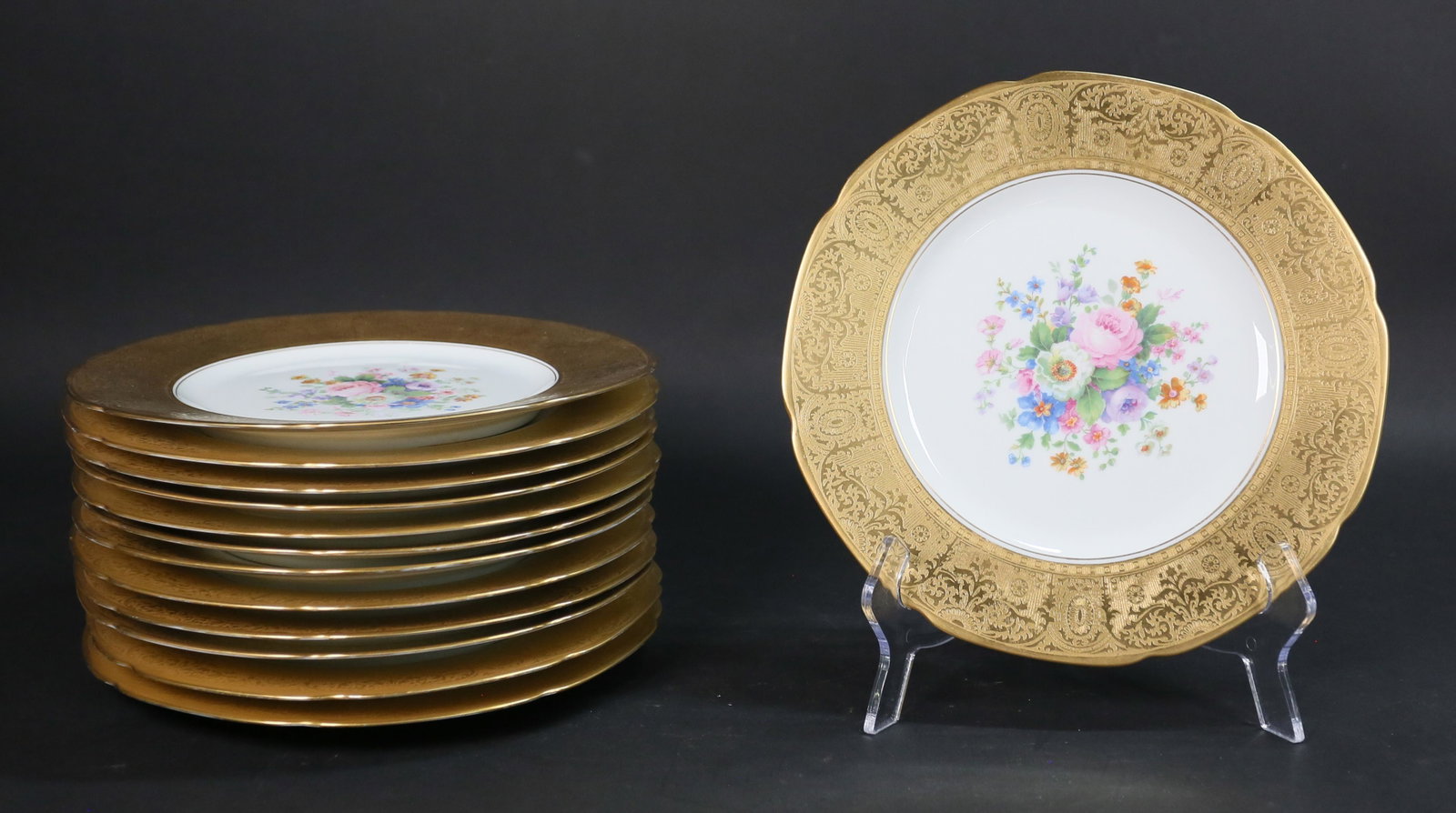 13 Hutschenreuther Gilt Dinner Plates: 13 Hutschenreuther gilt rimmed dinner plates, with transfer floral decoration. All marked Roya Bavarian China Hutschenreuther Selb Bavaria, with lion. Each plate 10 3/4"-diameter. Minor scratches to g