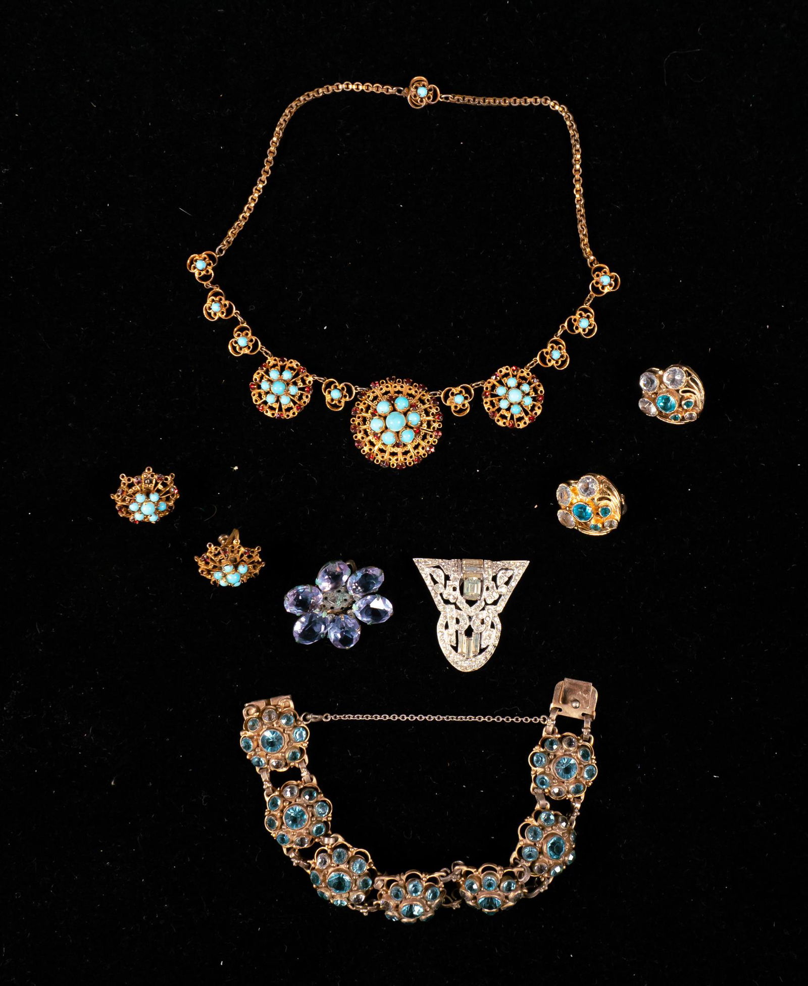 Lot of Sterling Jewelry: Lot of sterling silver jewelry. Jay Kel necklace and earring set with turquoise and garnets, sterling pin, single sterling earring, pair of earrings, bracelet. All marked sterling. Bracelet 2 1/2" ins