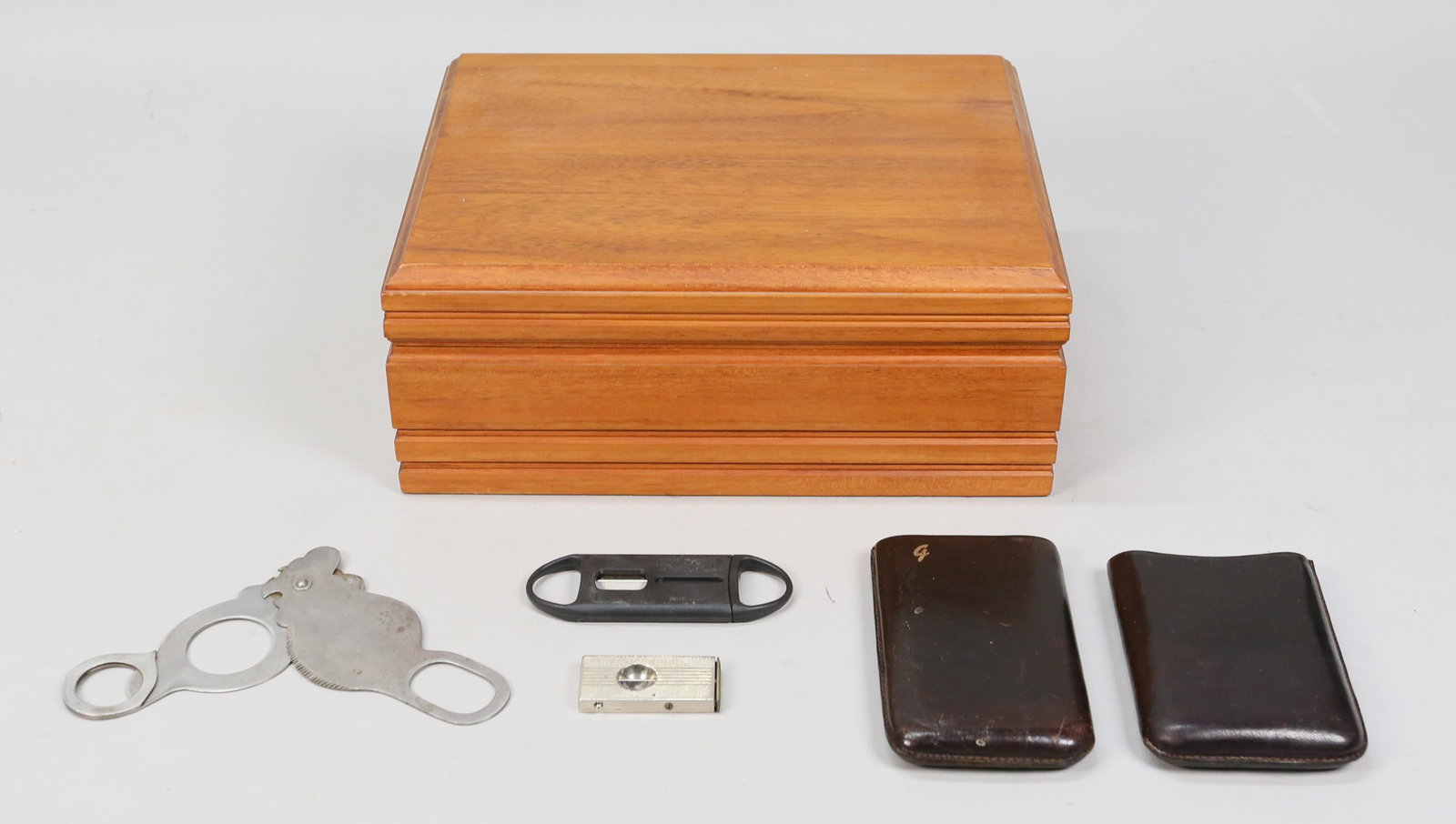 Credo Cigar Humidor: Credo cigar humidor with 2 cigar holders, and 3 cigar cutters. 4 1/2" H x 11" L x 8 3/4" W.