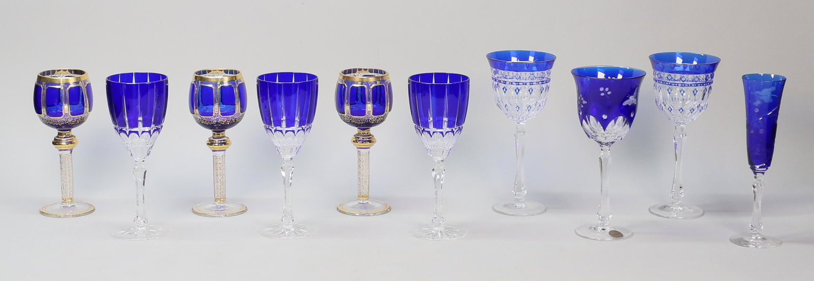 10 Pieces Cobalt Cut to Clear Stemware: 10 pieces cobalt cut to clear stemware. Set of 3 Moser style cobalt and gilt decorated goblets, each 8"H; set of 3 goblets, each 8 1/2"H; pair of signed Varga goblets, each 8 3/4"H; signed Varga butte