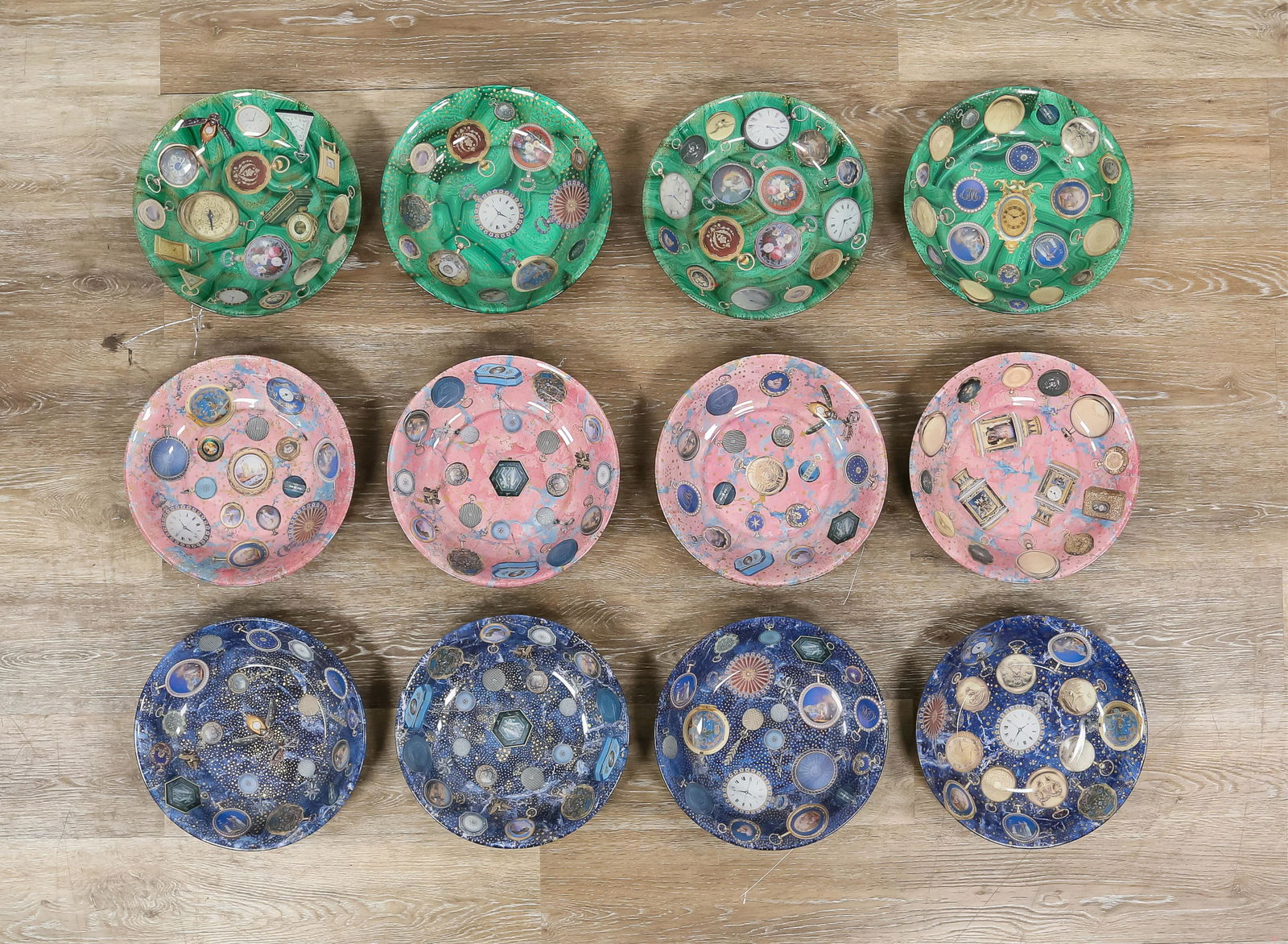 12 Pablo Manzoni Glass Pocket Watch Bowls: Pablo Manzoni (Italy / American, New York, 1939-2022). 12 glass bowls with collage designs and painted backs. All with pocket watch motifs, 4 green, 4 blue, 4 pink. All signed Pablo Manzoni N.Y.C. on