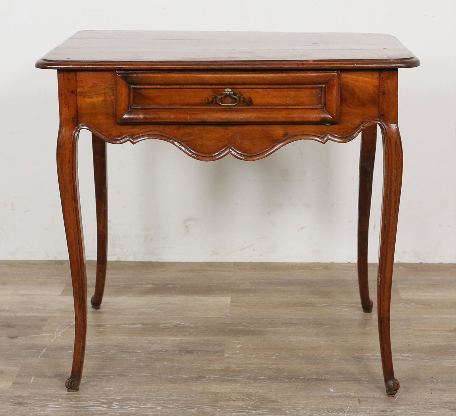 French Provincial Lady's Writing Desk: French Provincial lady's writing desk. 19th century. Cherry, one drawer, cabriole legs. Heavy scratches and marks across top of desk. Split to wood on top. Pitting and marks along length of apron. Spl