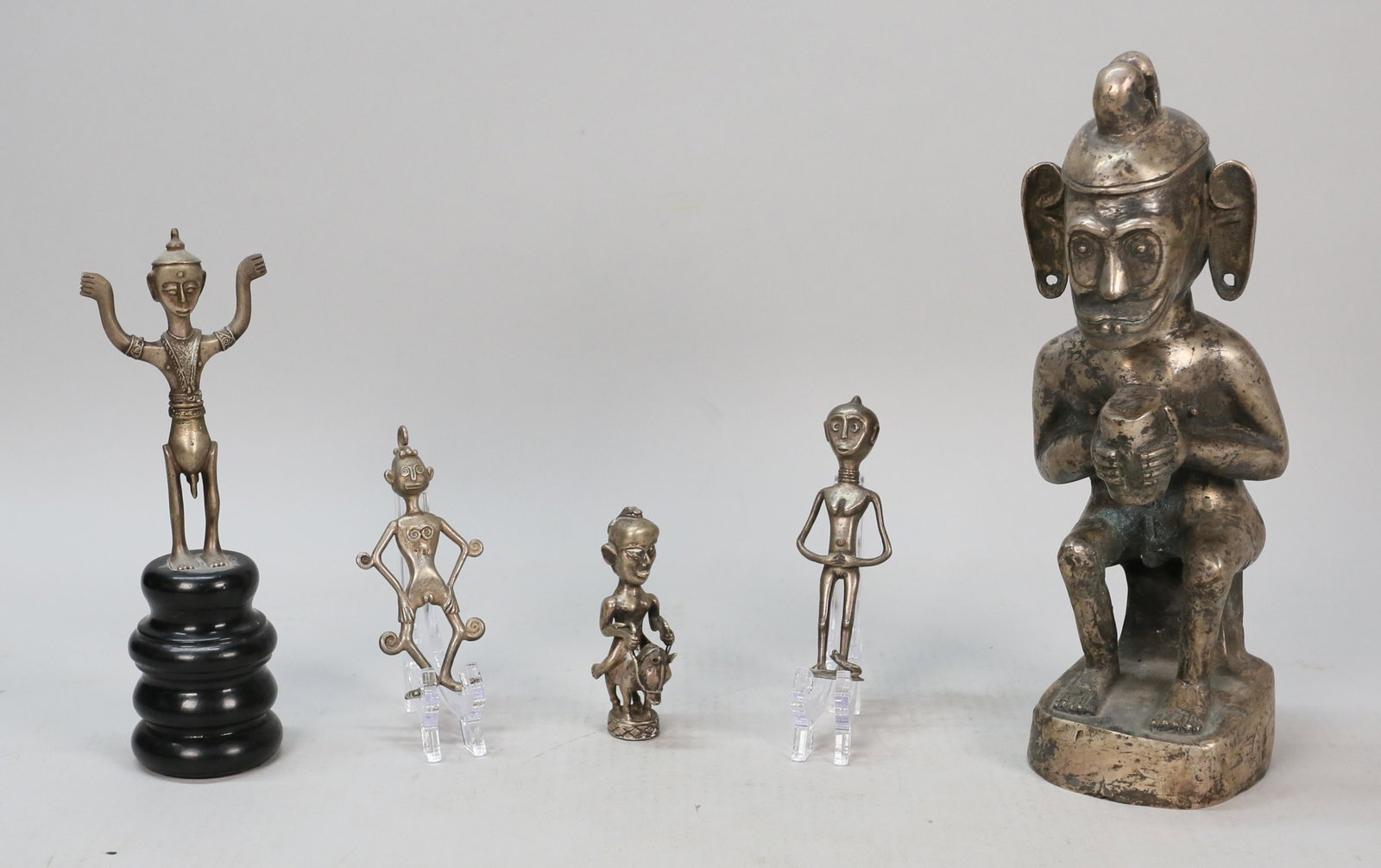 5 Ethnographic Metal Sculptures: 5 Ethnographic metal sculptures. 2 African style, 1 Malaysian style. 1 Indian style on pedestal. 1 large metal deity sculpture. Deity sculpture: 12" H.
