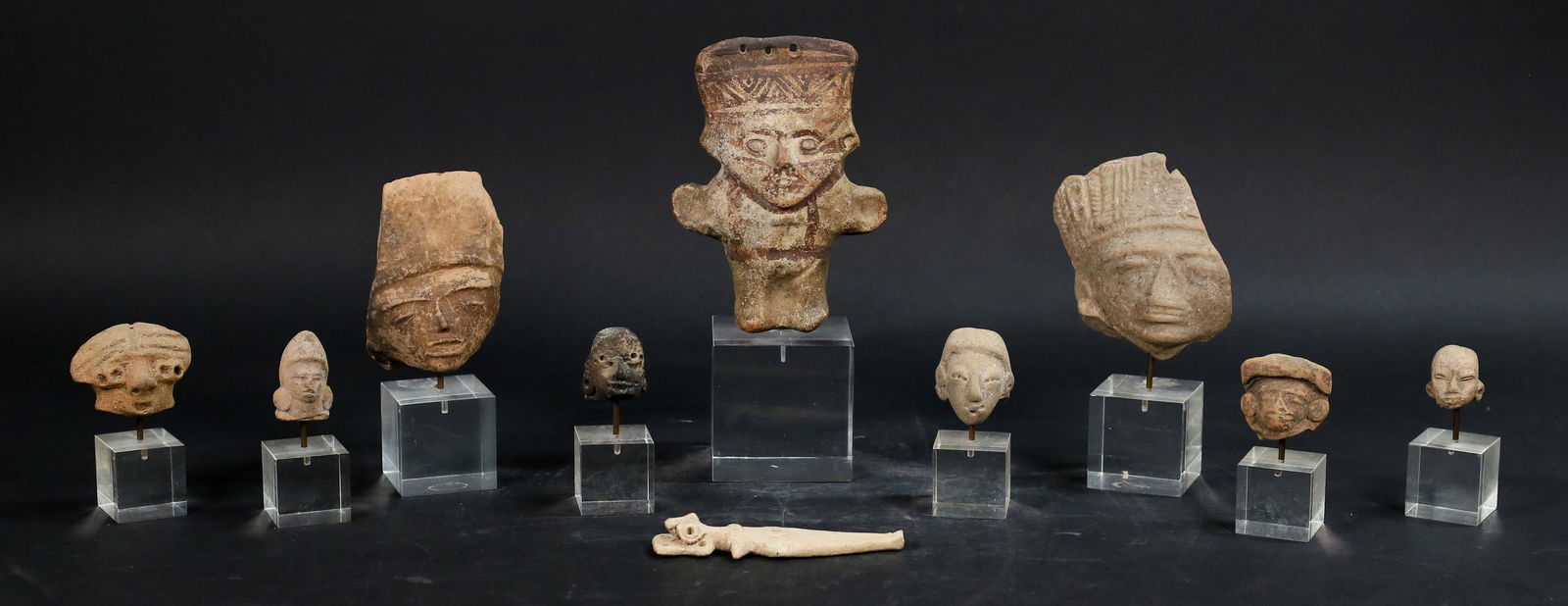 9 Pre-Columbian Terra Cotta Pottery Heads, Ishtar: 8 pre-Columbian terra cotta pottery heads and 1 figure, all on Lucite bases. Figure 6 1/4"H (9"H with base), larger head fragment 4 1/2"H x 4"W (6 3/4"H with base); terra cotta Inanna figure, 5"L.
