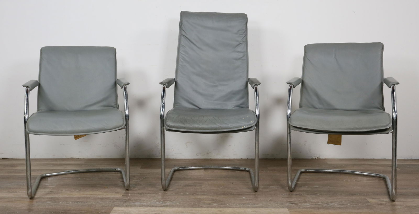 3 Cy Mann Designs Mies van der Rohe Style Chairs: Ludwig Mies van der Rohe (Germany 1886-1969) style chairs produced by Cy Mann Designs for their Designer's Collection. New York, 20th century. Gray leather seating and tubular chrome base and supports