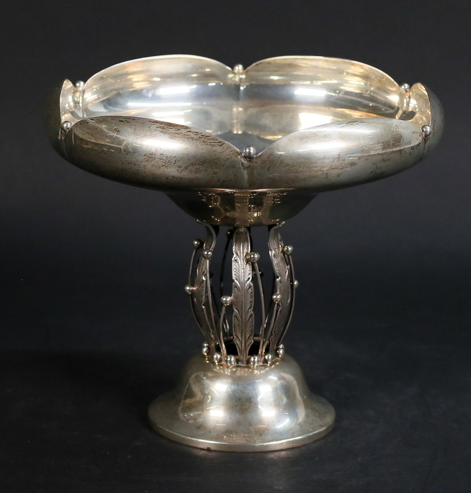 Georg Jensen Style Modernist Sterling Compote: Modern sterling silver compote in the style of Georg Jensen. Scalloped bowl on openwork leaf and berry pedestal. Marked Sterling 300 on the underside. 8 1/4"H x 9"-diameter at top. 805.8 grams. Scratc