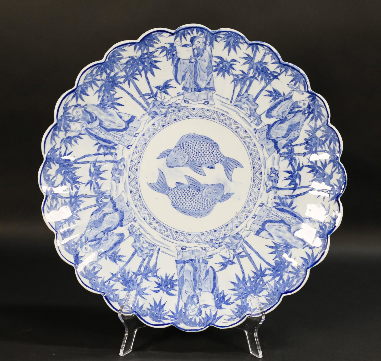 Japanese Blue & White Porcelain Charger: Japanese porcelain blue and white charger, with scalloped edge and fish motif. 16 1/2"-diameter. Roughness to edge, minor glaze imperfections throughout.