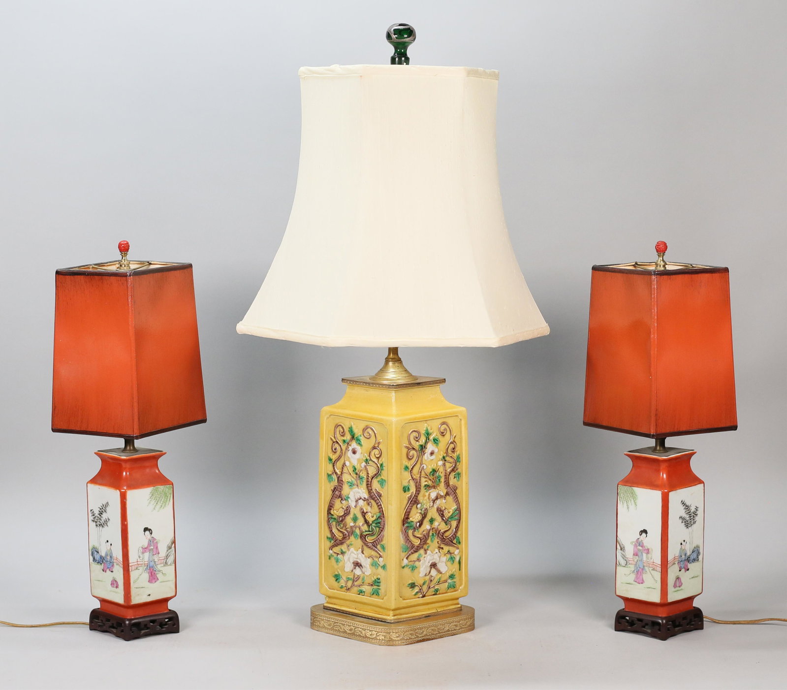 3 Chinese Porcelain Lamps: 3 Chinese porcelain diamond-shaped vases, mounted as lamps. Pair, with lacquered shades and cinnabar finials, each 19 3/4"H including finials; single lamp with relief dragon motif, 30"H including fini