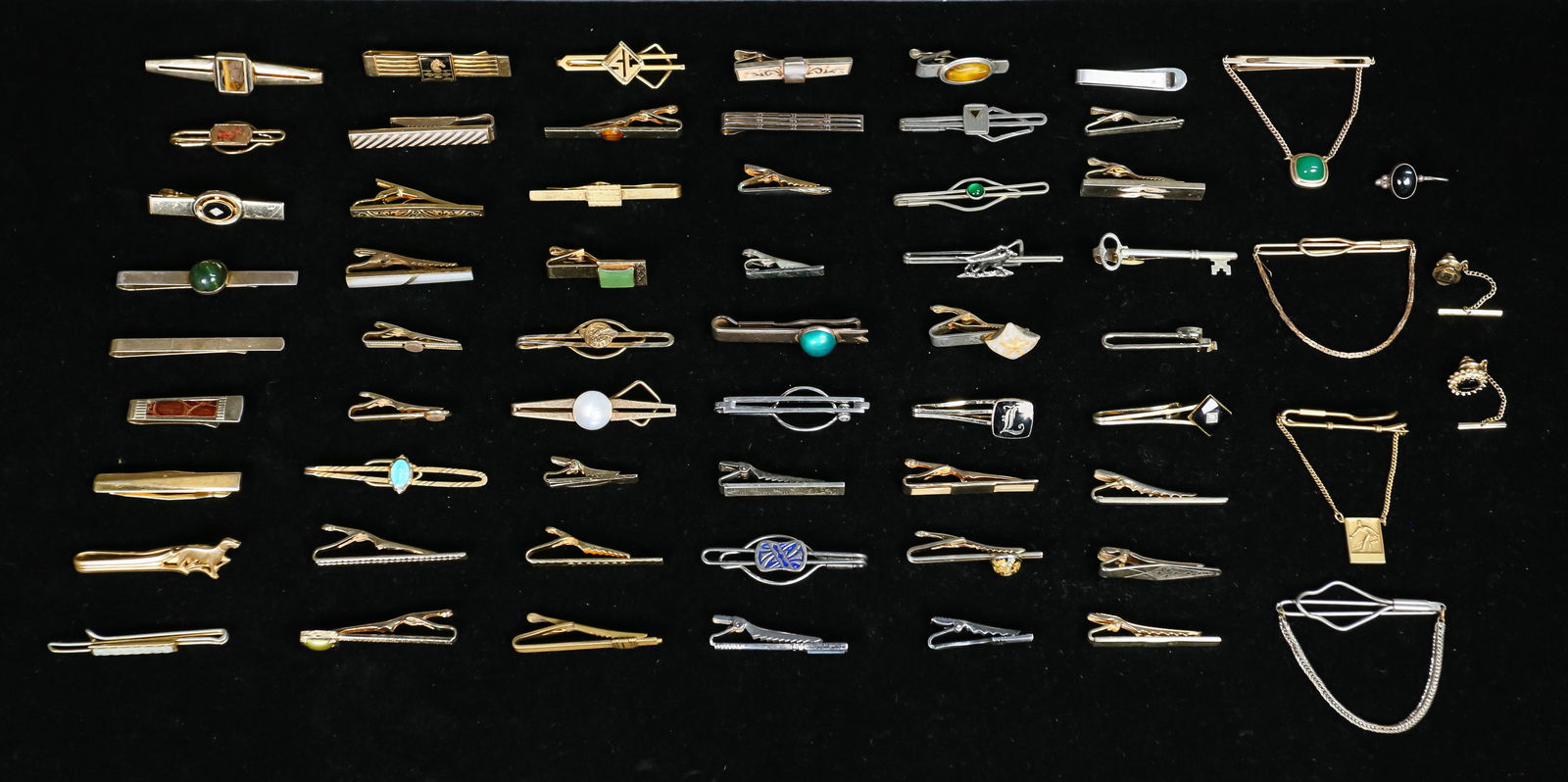 Collection of Men's Tie Clips: Collection of Men's tie clips. Designers include Swank, Anson, Avon, and Dante. Gold and silver tone. Additionally of 3 sterling tie clips and an earring. 22.0 grams including stones. From the estate