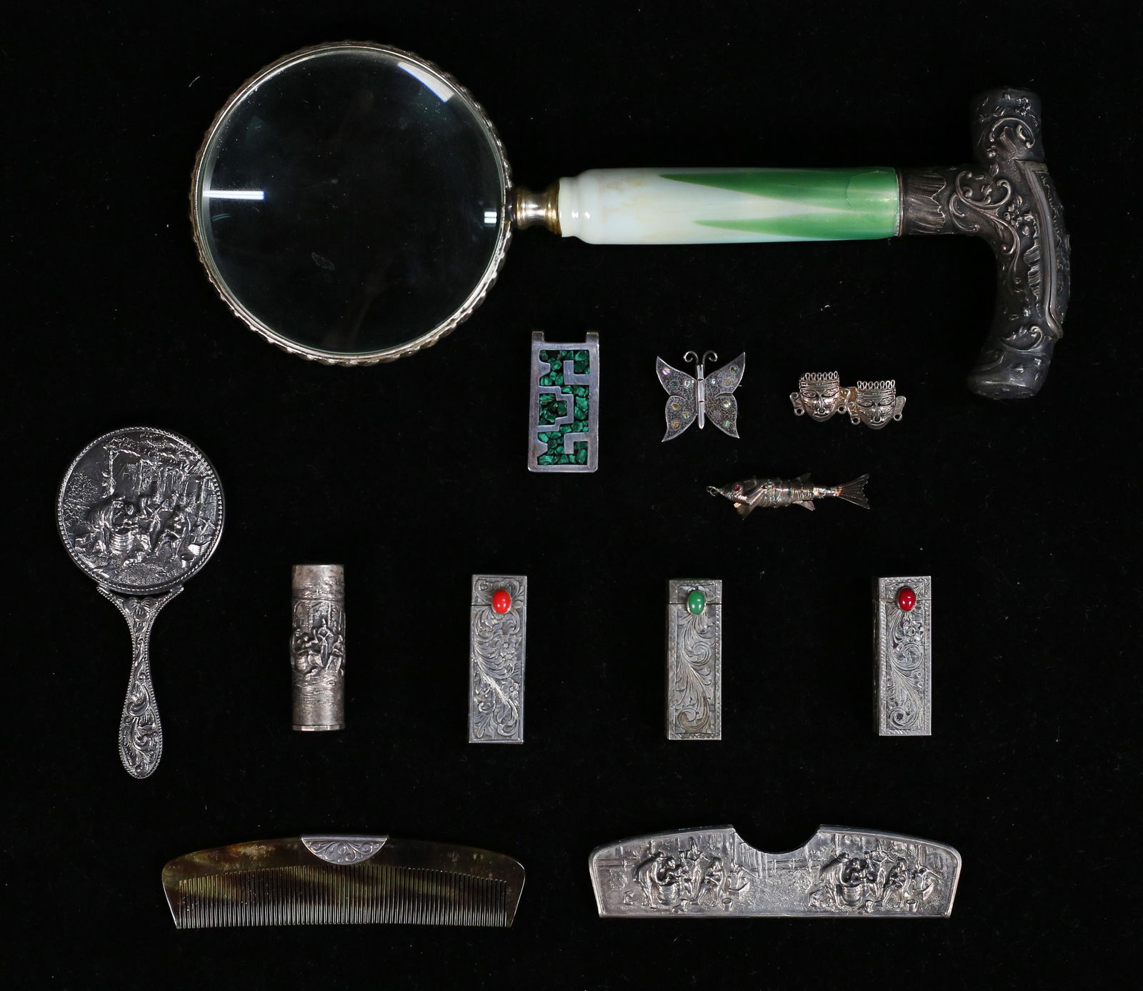 Silver & Silverplate Jewelry & Dresser Items: 4 pieces sterling jewelry: Mexican sterling money clip with malachite chip inlays, Taxco butterfly pin, Mexican sterling mask pin, unmarked sterling articulated fish pendant; magnifying glass with sil