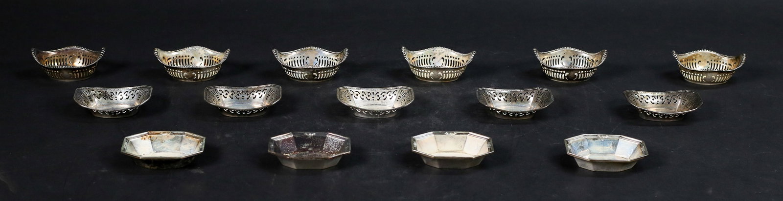 Lot of Sterling Nut Dishes: 3 sets of sterling silver nut dishes. Set of 6 Gorham nut dishes, set of 5 Webster nut dishes, set of 4 Whiting nut dishes. Gorham 3 1/4"L. 294.2 grams total. 2 Gorham with bent rims, 1 Webster bottom