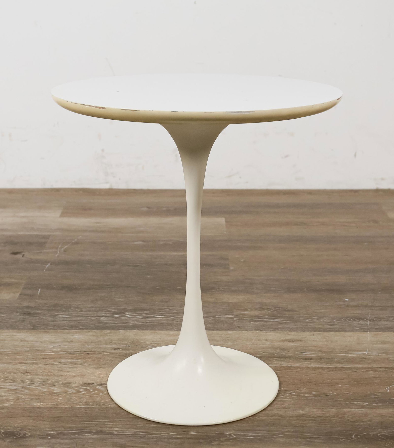 Tulip Side Table Attributed to Eero Saarinen: Eero Saarinen (Finland, 1910-1961). White laminate top, cast aluminum base. No labels present. Spotting and staining to top, spotting, scuffs and light scratches to base. Losses to laminate on edge of