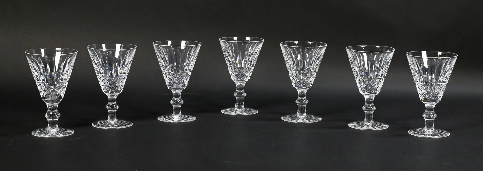 7 Waterford Tramore White Wines: Set of 7 Waterford Tramore pattern crystal white wine glasses. Each 5"H. All with etched Waterford marks.