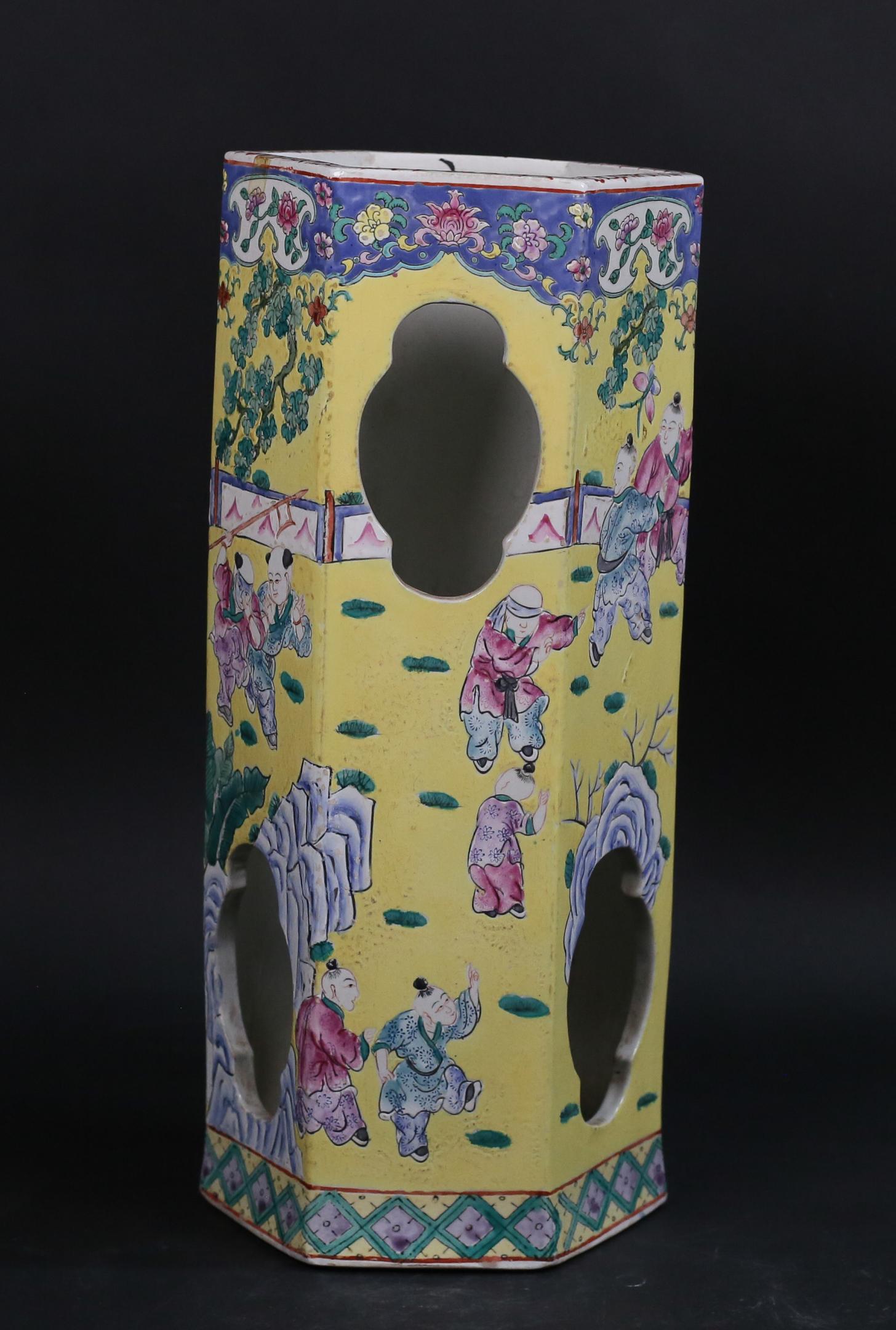 Famille Rose Chinese Porcelain Hat Stand: Famille rose Chinese porcelain hat stand. Octagonal form, yellow ground with figures. Red Qing style mark to the underside. 15 1/2"H x 6 3/4"W. Crazing and scratches throughout.