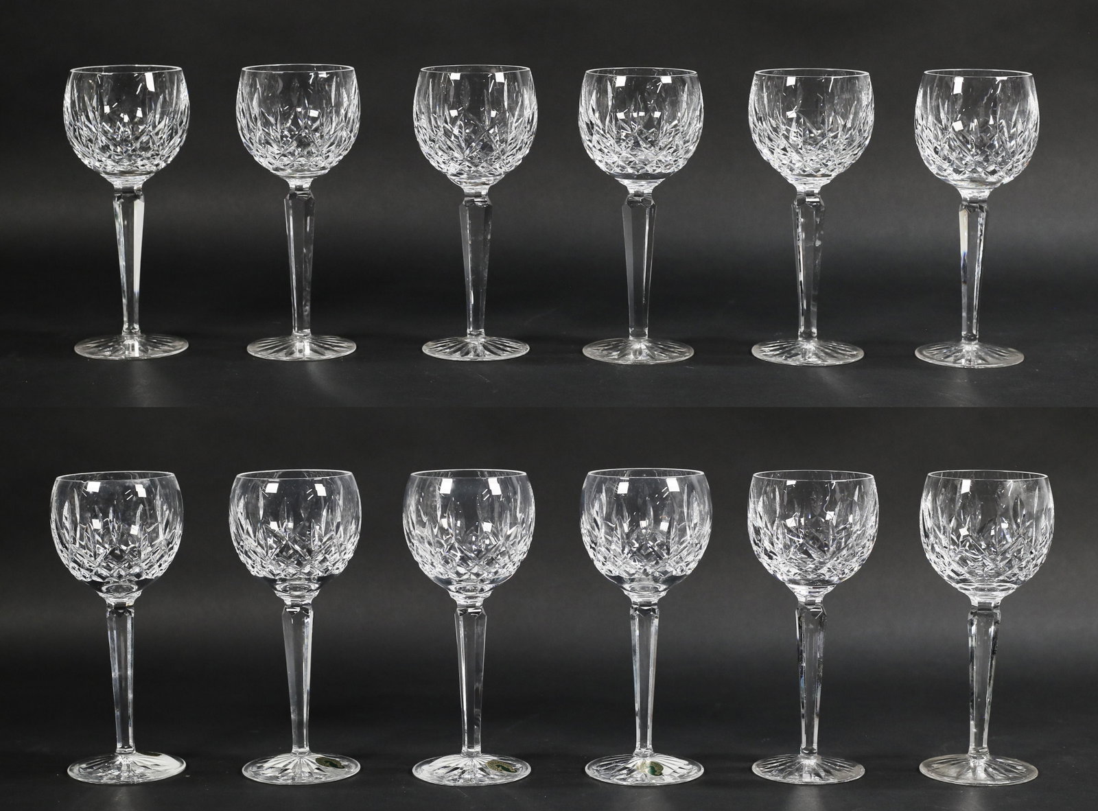 12 Waterford Lismore Crystal Hock Wine Glasses: 12 Waterford Lismore crystal hock wine glasses 7.5" tall. 4 new in box, boxes show signs of wear and staining. 8 used wine glasses have older mark and have some surface scratches from use, no chips or
