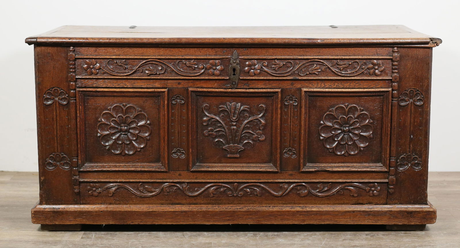 Carved Jacobean Blanket Chest: Carved Jacobean blanket chest. Pre 18th century. Carved oak, iron hinges, handles, and escutcheon, carved foliate motifs. Interior lined with linen, with one lidded compartment on right side. Split to