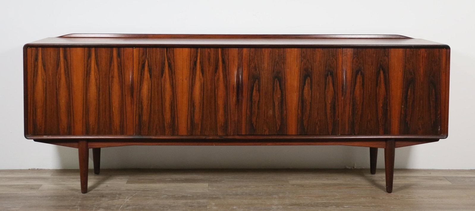 Bernhard Pedersen Danish Modern Sideboard: Bernhard Pedersen (Danish, 20th century). Sideboard produced by Bernh. Pedersen and Son, circa 1965. Rosewood, four doors, three dovetailed felt-lined flatware drawers, two shelves, felt lined liquor 