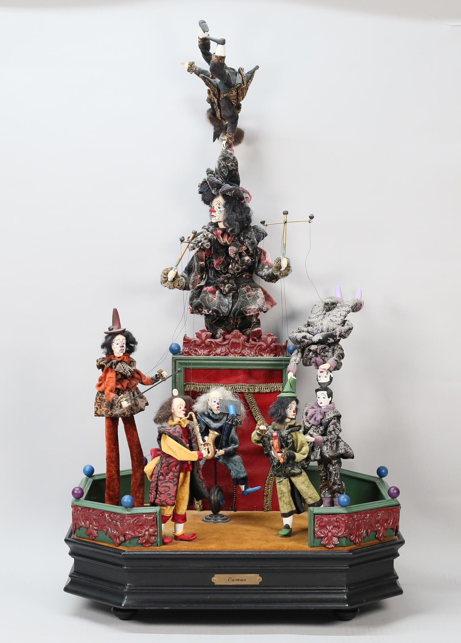 Jean-Pierre Camus Musical Automaton Puppet Band: Jean-Pierre Camus French musical automaton clown marionette band. 19 1/4" x 13 1/4" x 35"H. Partially working condition, some pieces slow or loose. Chips and losses to fingers, crack to leg of puppete