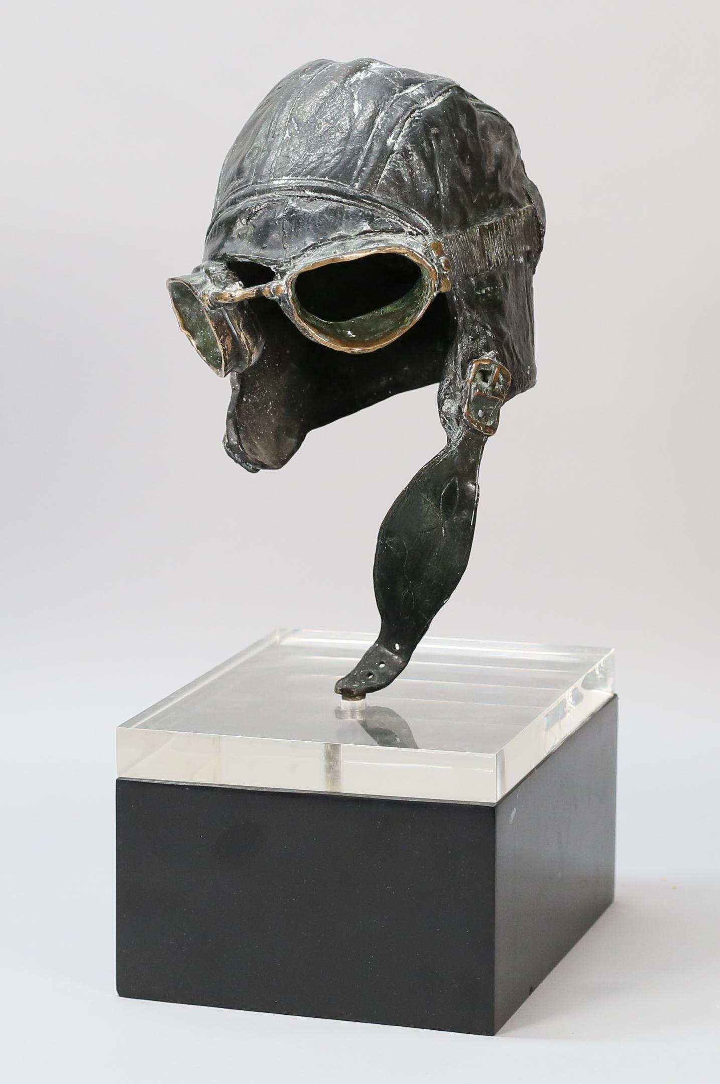 John Nelson Battenberg Sculpture Helmet: John Nelson Battenberg (American, 1931-2012). Aviator's helmet, patinated bronze sculpture on plexiglass and wooden base. Signed and dated on the chin strap. With receipt from Krasner Gallery, Madison