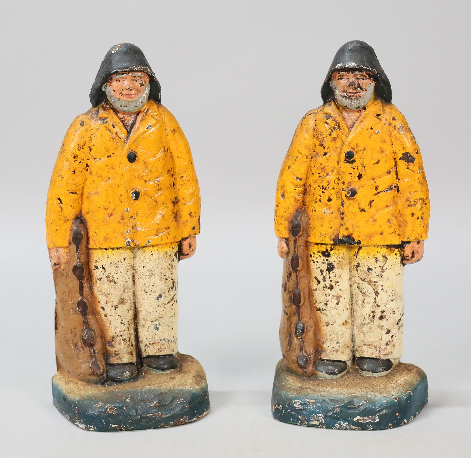 Pair of Cast Iron Fisherman Bookends: Pair of paint decorated cast iron fisherman bookends. Each 8 1/8"H. Paint loss to both.