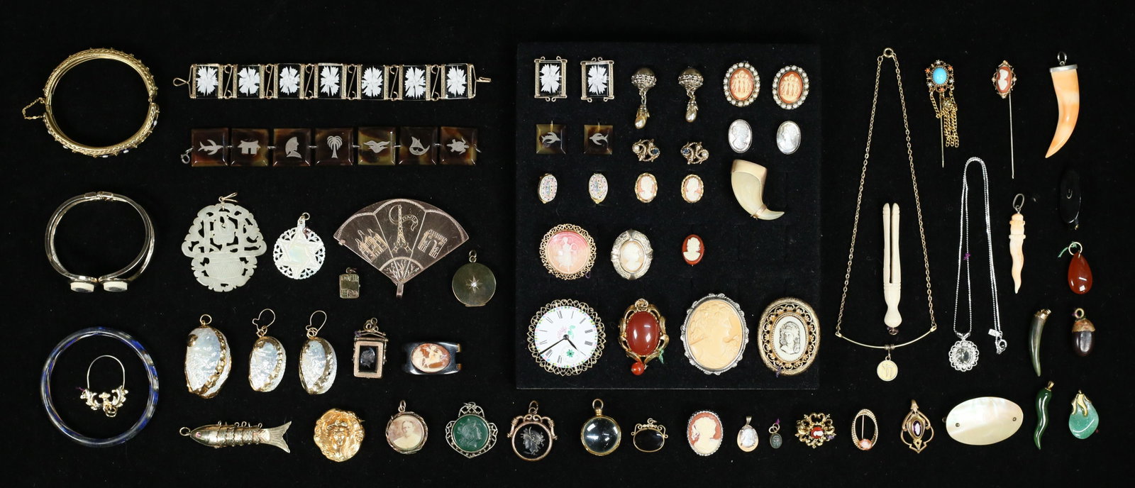 Lot of Cameos, Pendants, Bracelets, Earrings: Grouping includes cameo brooches and earrings, gold tone cameo bracelet, carnelian brooch, pendants of mother of pearl, shell, bone, glass, carved stone, black flower bracelet, 7"L.
