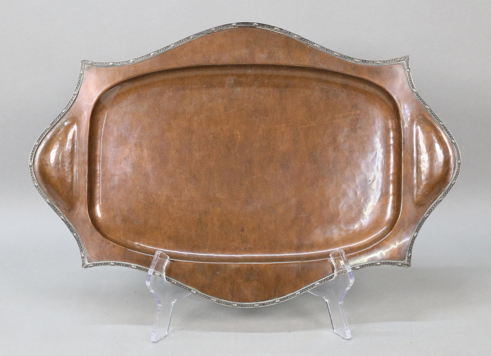 A.E. Jones Copper & Silver Tray: Patinated copper tray with silver rim. Unsigned, attributed to A.E. Jones, circa 1910-1920. Impressed on the underside 2503.16"L. Scratches and minor losses to the copper patina, scratches to the unde